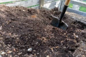 Compost bin with shovel